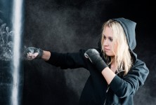 Blond boxing woman in black punching bag Blond boxing woman in black punching bag
